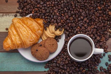 Cup of coffee with coffee beans backgroundの写真素材