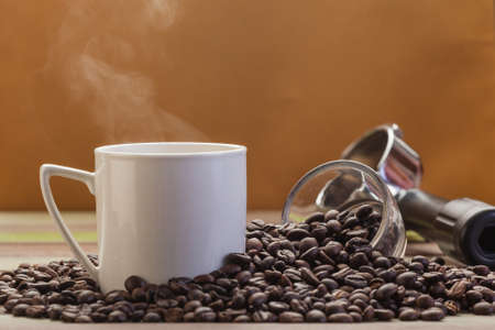 Coffee cup with coffee beans and cookies backgroundの写真素材