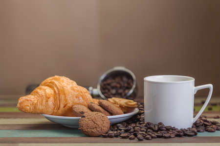 Cup of coffee with coffee beans backgroundの写真素材
