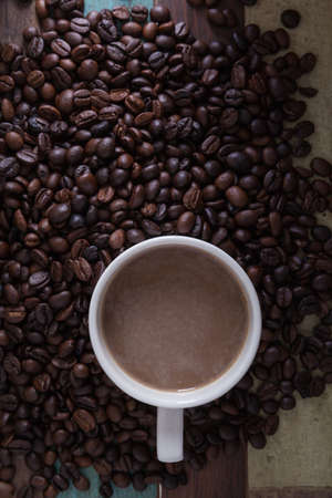 Cup of coffee with coffee beans backgroundの写真素材