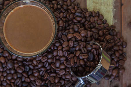 Cup of coffee with coffee beans backgroundの写真素材