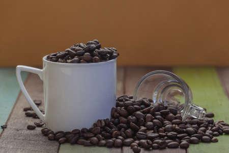 Coffee beans in white cup with clear glass close upの写真素材
