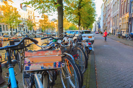 Bicycles with Amsterdams cityscape at sunset, The Netherlandsのeditorial素材
