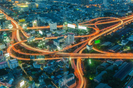 Long exposure of car light on express way cross road, Bangkok skyline in Thailandの写真素材