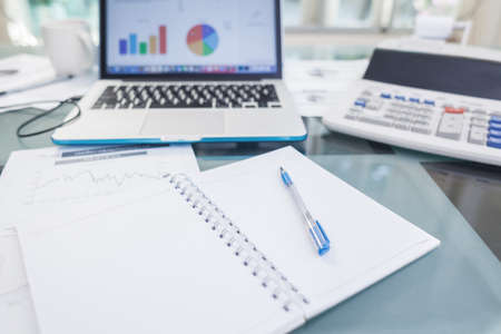 Open laptop and accessories with coffee cup for home workplaceの写真素材