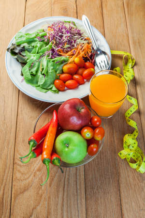 Healthy concept with mixed fruits and vegetables on wooden backgroundの写真素材