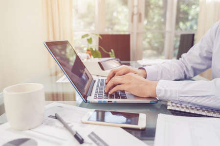Business man working on open laptop at home officeの写真素材