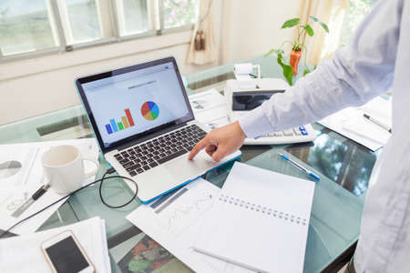 Open laptop and accessories with coffee cup for home workplaceの写真素材
