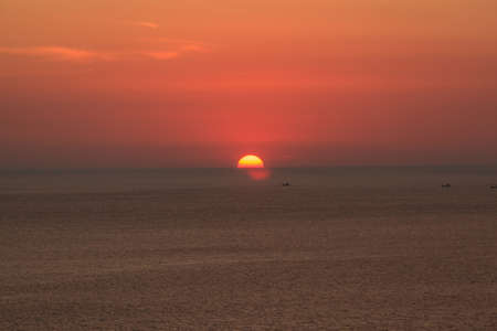 Seascape of sunset against Promthep cave with blue sky background at  Phuket, Thailand.の写真素材