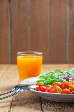 Healthy concept with mixed fruits and vegetables on wooden backgroundの写真素材