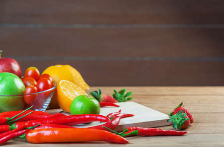 Healthy concept with mixed fruits and vegetables on wooden backgroundの写真素材