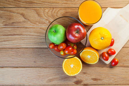 Healthy concept with mixed fruits and vegetables on wooden backgroundの写真素材