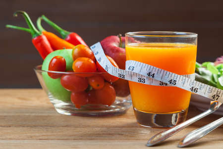 Healthy concept with mixed fruits and vegetables on wooden backgroundの写真素材