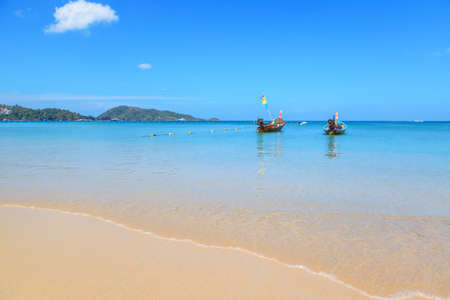 Long tail boats at the beautiful beach in Phuket, Thailandの写真素材
