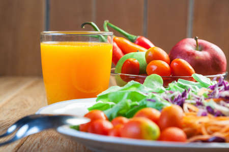 Healthy concept with mixed fruits and vegetables on wooden backgroundの写真素材