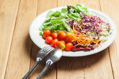 Healthy concept with mixed fruits and vegetables on wooden backgroundの写真素材