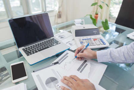 Business man writing on notebook during working at homeの写真素材