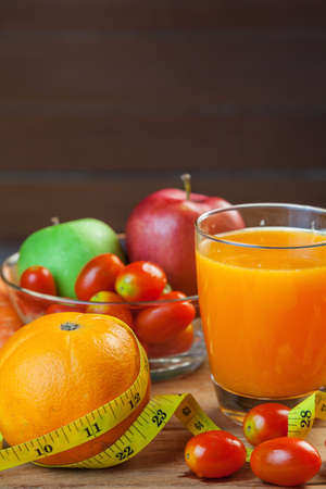 Healthy concept with mixed fruits and vegetables on wooden backgroundの写真素材