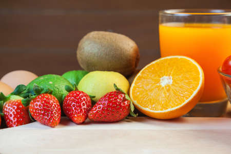 Healthy concept with mixed fruits and vegetables on wooden backgroundの写真素材