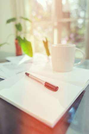 Open laptop and accessories with coffee cup for home workplaceの写真素材