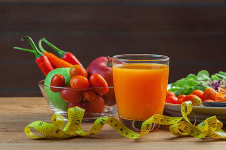 Healthy concept with mixed fruits and vegetables on wooden backgroundの写真素材