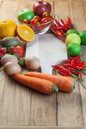 Healthy concept with mixed fruits and vegetables on wooden backgroundの写真素材