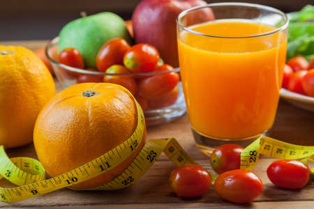 Healthy concept with mixed fruits and vegetables on wooden backgroundの写真素材