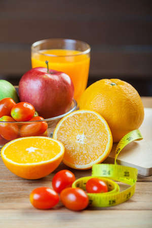 Healthy concept with mixed fruits and vegetables on wooden backgroundの写真素材