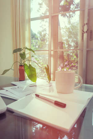 Open laptop and accessories with coffee cup for home workplaceの写真素材