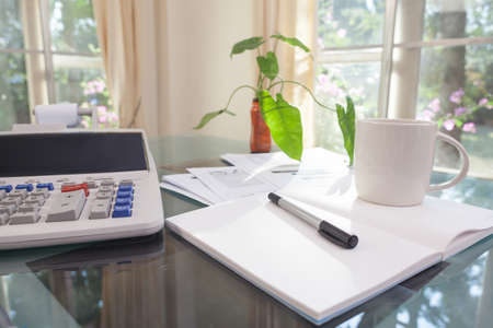 Open laptop and accessories with coffee cup for home workplaceの写真素材