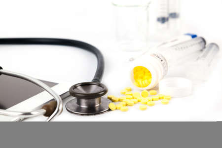 White tablet, laptop and doctor tools isolated on white backgroundの写真素材