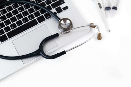 White tablet, laptop and doctor tools isolated on white backgroundの写真素材