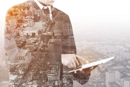 Double exposure of business man holding tablet isolated on white backgroundの写真素材