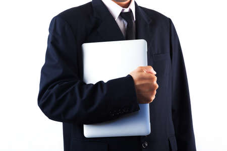 Business man holding laptop isolated on white backgroundの写真素材