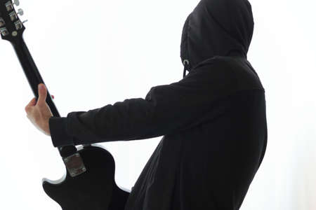 black clothes guitarist  posing with his guitarの写真素材
