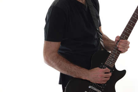 rocker guitarist play his black guitar の写真素材