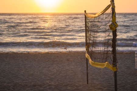 volleyball net and sunset together in to the beachの写真素材