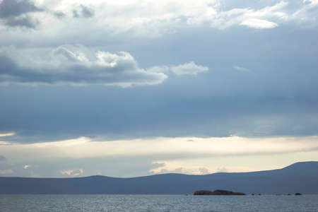 Heavy clouds and sea views and small islandの写真素材
