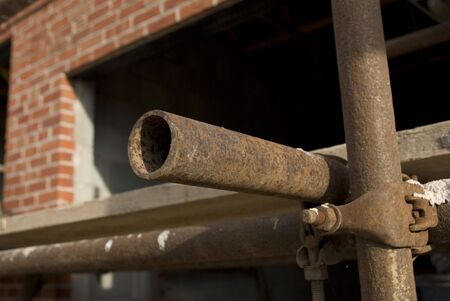 Rusty construction site scaffold bracket and tube detailの写真素材