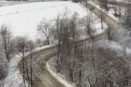 road in winter with curves seen from distance - stock photoの写真素材