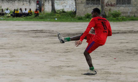 ZANZIBAR, TANZANIA - MARCH 26 2013: local african soccer team during training on sand playing fieldのeditorial素材