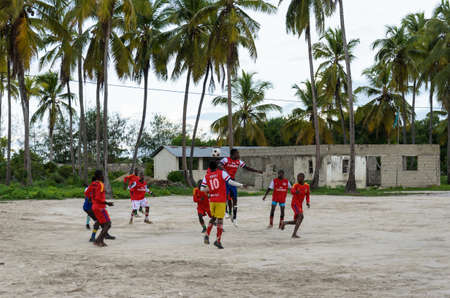 ZANZIBAR, TANZANIA - MARCH 26 2013: local african soccer team during training on sand playing fieldのeditorial素材