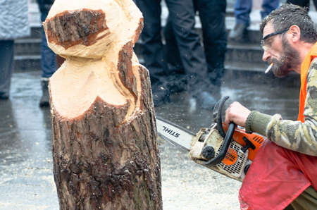 KIEV, UKRAINE, 2 JANUARY 2014: artist carving wood with chainsaw during euromaidan in ukraineのeditorial素材