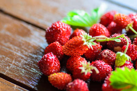 closeup of wild strawberries on wooden table - stock photoの写真素材