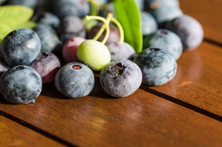 pile of blueberries lying on wooden table の写真素材