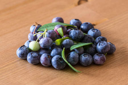 pile of blueberries lying on wooden table の写真素材
