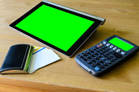 workplace with tablet pc - green box, calculator and bussiness card - stock photoの写真素材
