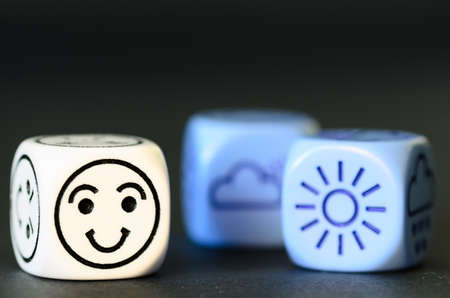 concept of good  summer weather - emoticon and weather dice on black background - stock photoの写真素材
