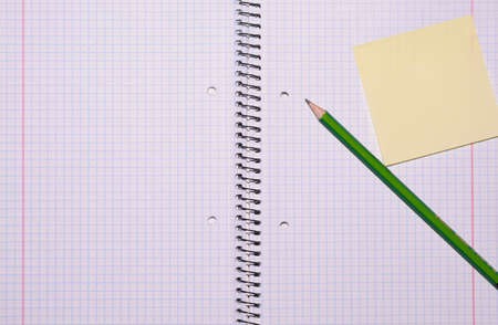 open exercise book with sticky card and pencil seen from top - stock photoの写真素材