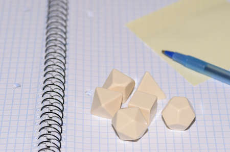 open exercise book with sticky card, pen and rpg blank dices - stock photoの写真素材